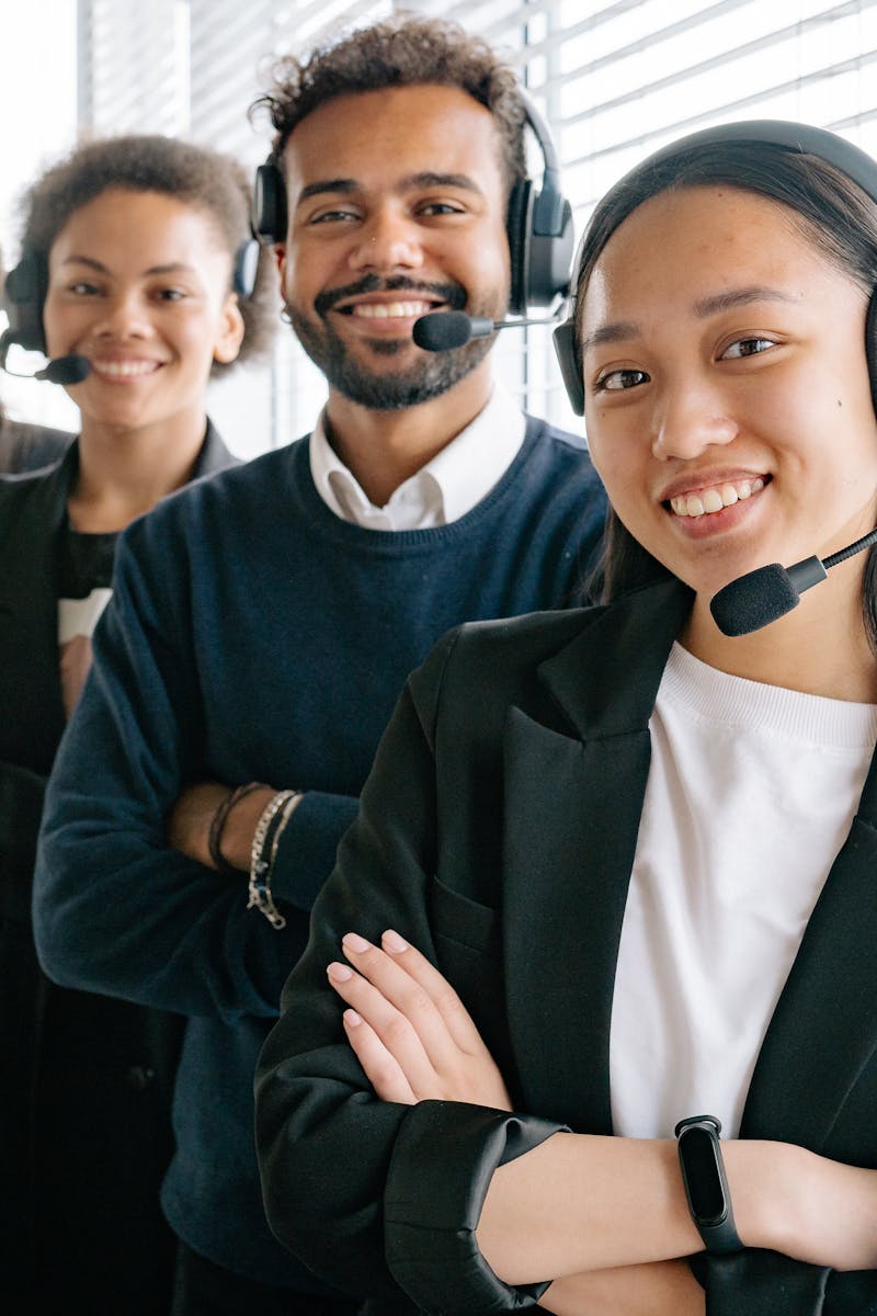 About A diverse group of smiling call center agents in an office setting.